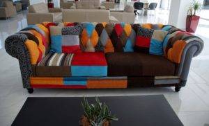 Colorful patchwork sofa in a modern setting, showcasing upholstery design relevant to The One Carpet Cleaning's upholstery cleaning services.